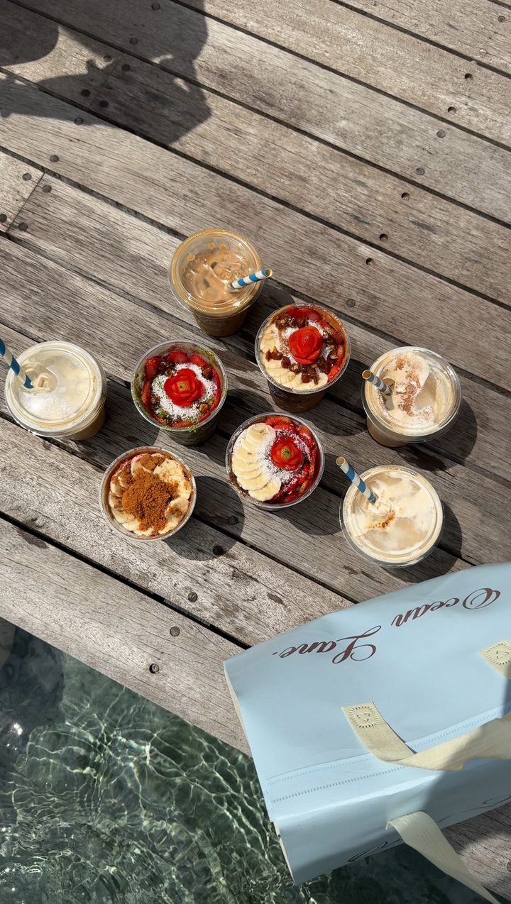 Breakfast bowls and iced coffees on a dock
