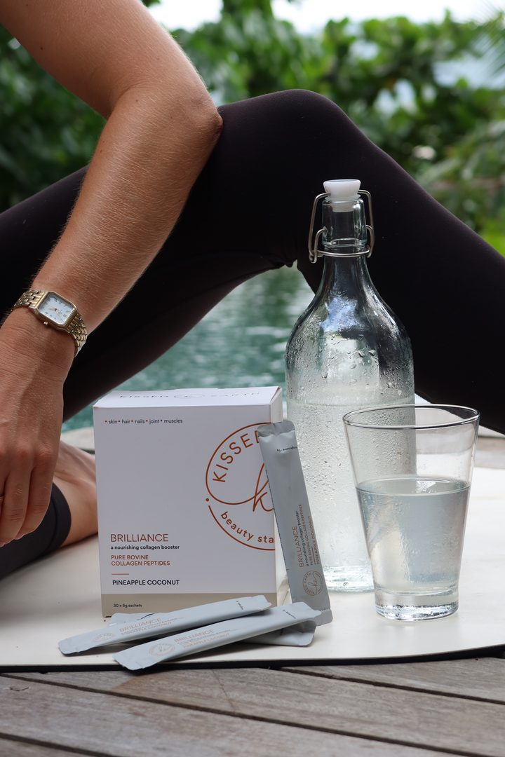 Kissed beauty sachets with a bottle of water by a pool